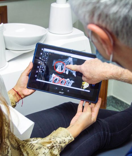 woman in blue denim jeans holding black tablet computer